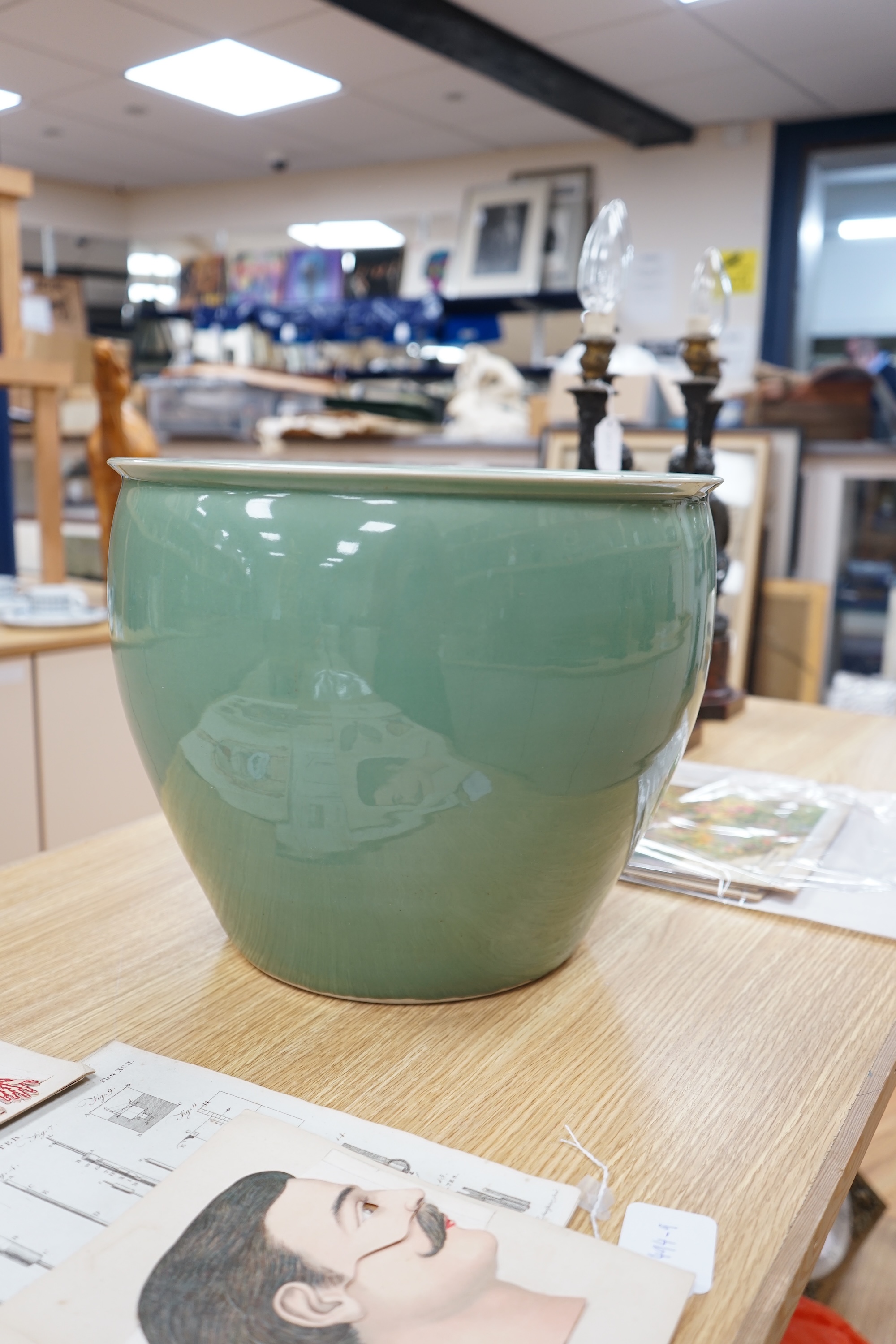 A large Chinese celadon glazed fish bowl or jardiniere, 30cm high, 37cm in diameter. Condition - good